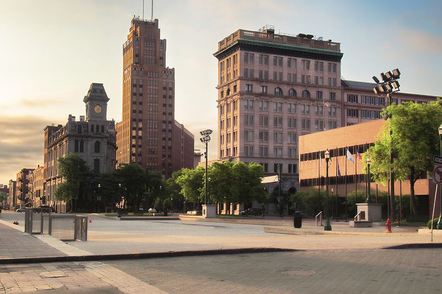 About Our Agency - View of Downtown Syracuse Commercial Buildings at Sunset